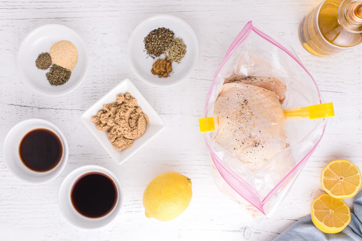 Chicken thighs in a bag, next dishes filled with spices.