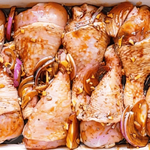 Drumsticks coated with a honey soy marinade and onions.