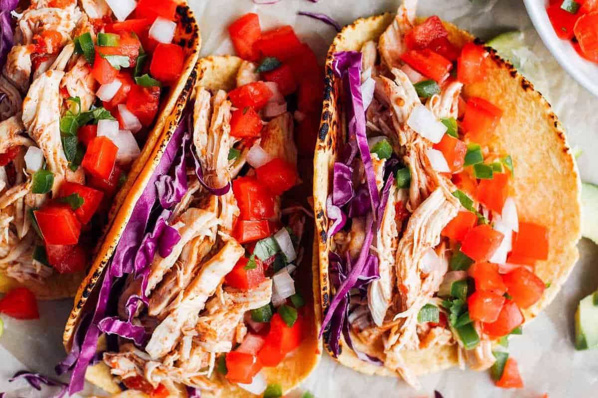 up close prepared instant pot chicken tacos in a row