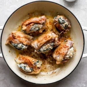 searing stuffed chicken thighs in a pan.