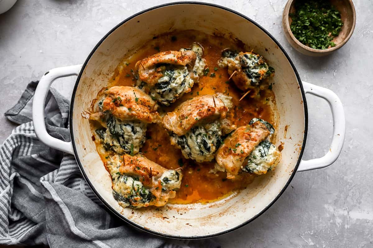 baked stuffed chicken thighs in a pan.