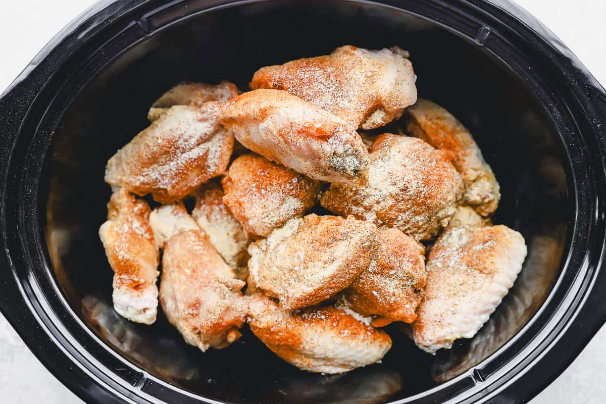 seasoned chicken wings in a slow cooker.