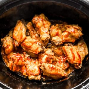 cooked and sauced chicken wings in a crockpot.