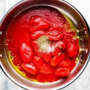 cooking tomato sauce in a pan.