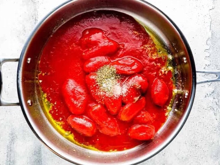 cooking tomato sauce in a pan.