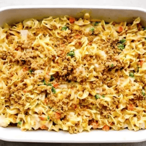 Unbaked chicken noodle casserole topped with breadcrumbs.