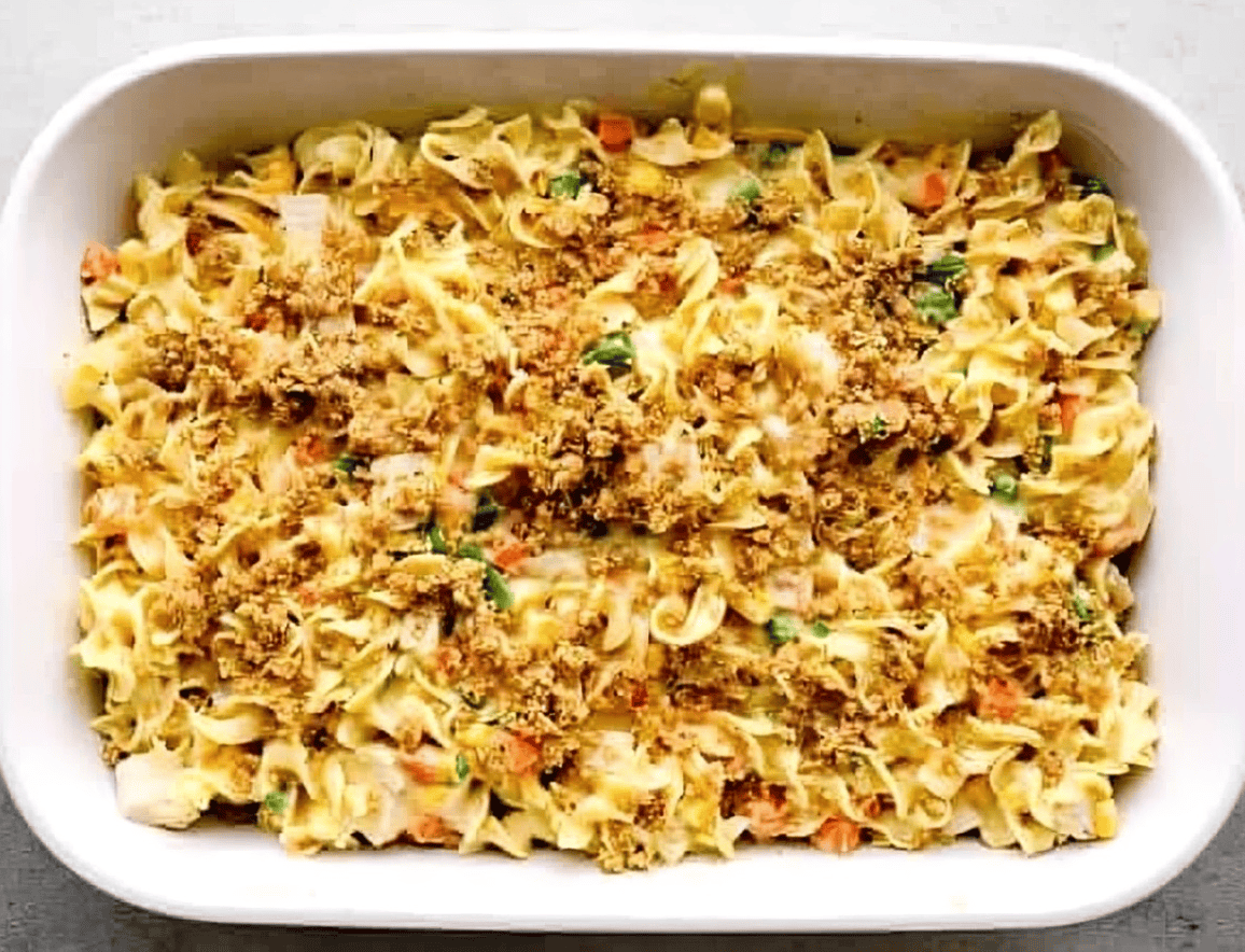 Unbaked chicken noodle casserole topped with breadcrumbs.