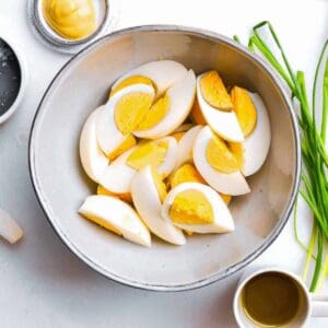 hard-boiled egg cut into quarters, in a bowl.