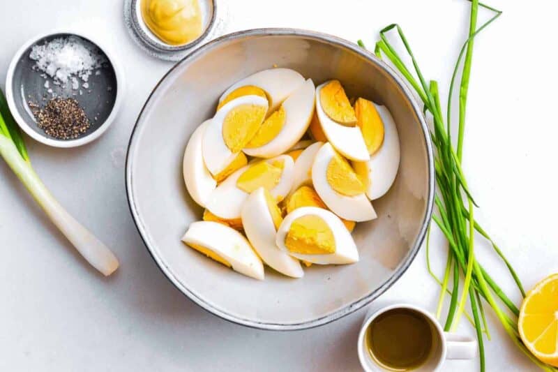 hard-boiled egg cut into quarters, in a bowl.