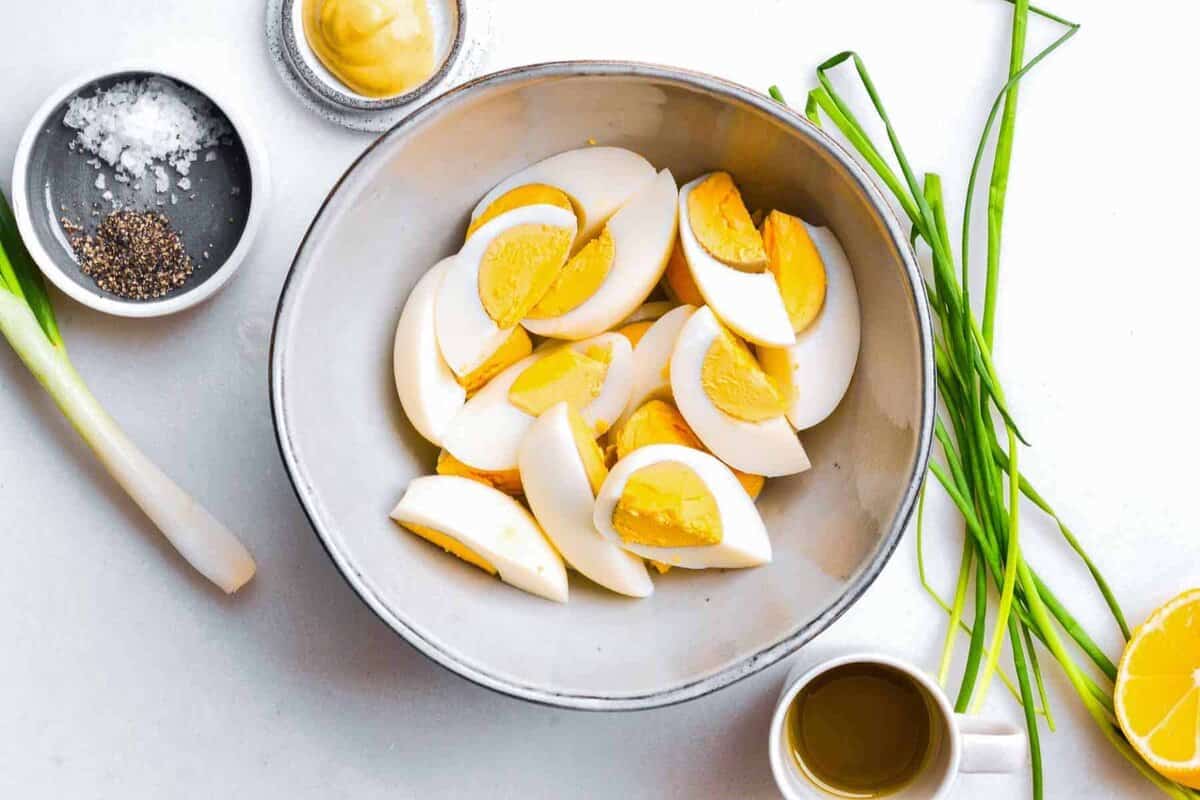 hard-boiled egg cut into quarters, in a bowl.
