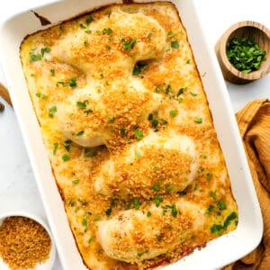 overhead view of four swiss chicken breasts in a casserole dish.