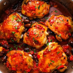 overhead view of chicken puttanesca in a sauté pan.