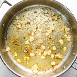 sautéed garlic and anchovy paste in a sauté pan.