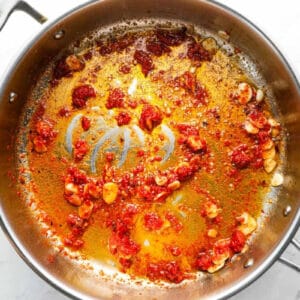 red pepper flakes and tomato paste added to sautéed garlic and anchovy paste.