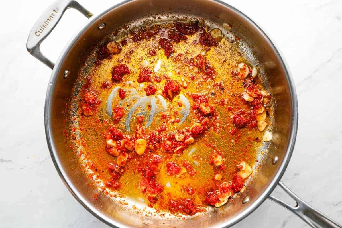 red pepper flakes and tomato paste added to sautéed garlic and anchovy paste.