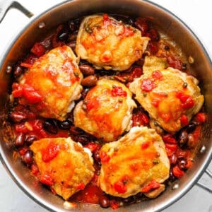 seared chicken thighs nestled in puttanesca sauce.