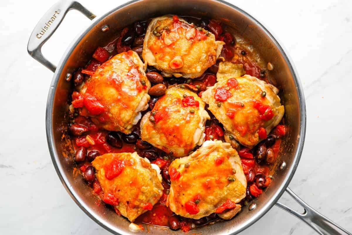 seared chicken thighs nestled in puttanesca sauce.