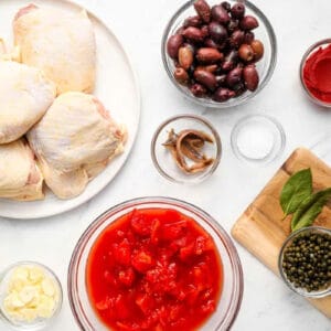 portioned ingredients for chicken puttanesca in individual containers.