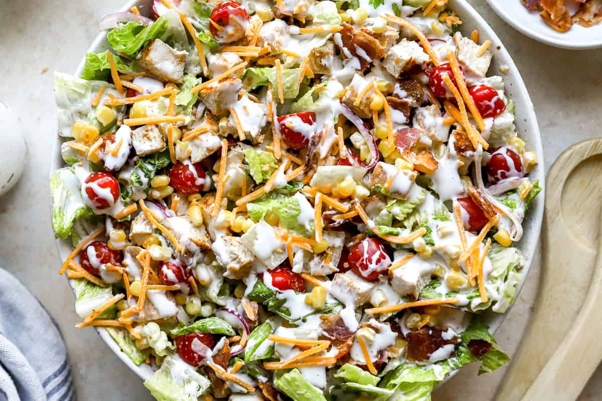 closeup overhead view of a dressed chopped chicken salad in a large serving bowl.