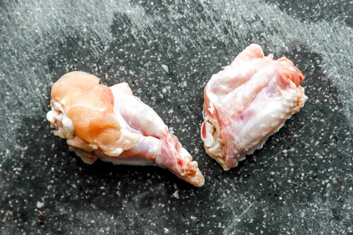 separated wing parts on a cutting board.