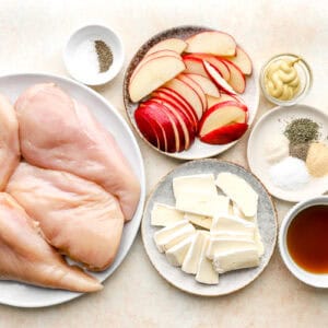 portioned ingredients for apple brie stuffed chicken on individual plates.