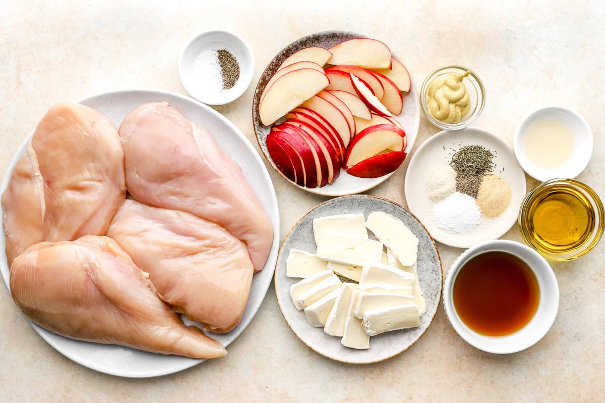 portioned ingredients for apple brie stuffed chicken on individual plates.