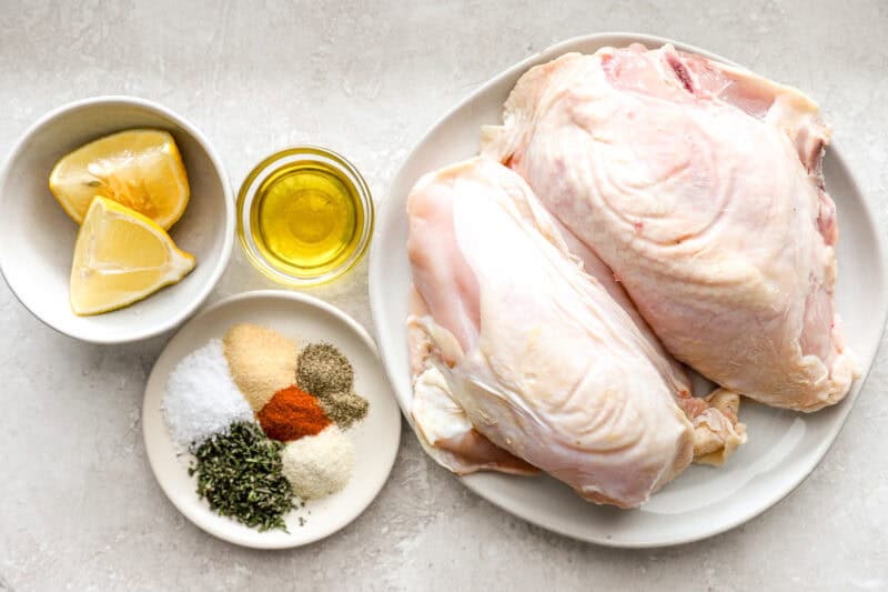 portioned ingredients for baked bone in chicken breasts in individual containers.