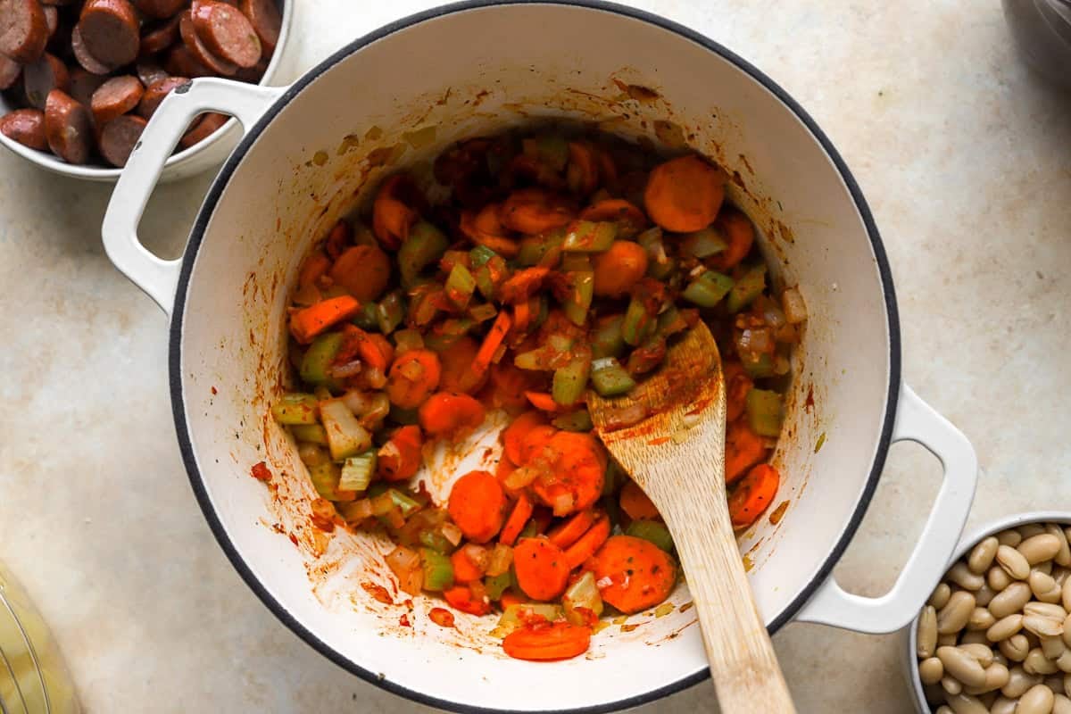 sauteeing veggies in a pot.