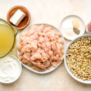 portioned ingredients for chicken and stuffing casserole in individual bowls.