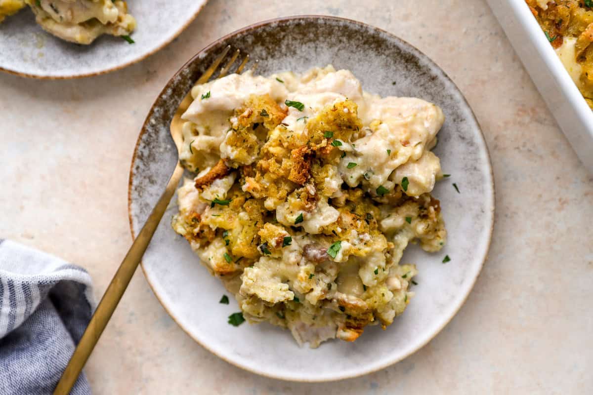 overhead view of a serving of chicken and stuffing casserole on a plate with a fork.