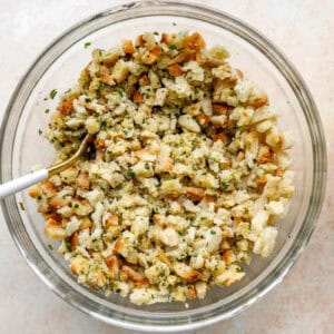 fluffy hydrated chicken stuffing mix in a glass bowl with a fork.