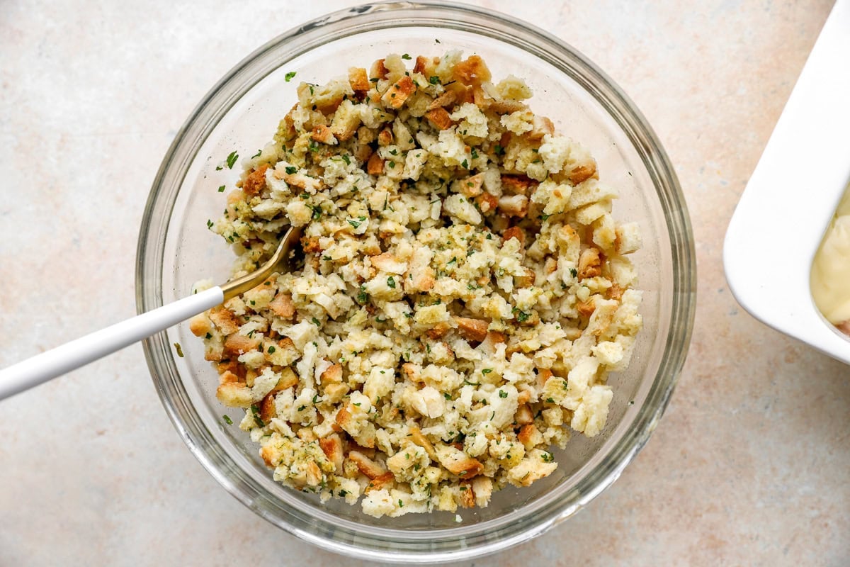 fluffy hydrated chicken stuffing mix in a glass bowl with a fork.