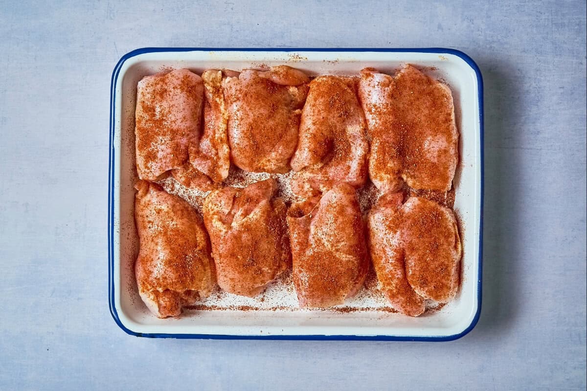 Raw chicken thighs seasoned with Chipotle spices.