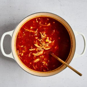 pozole rojo with chicken in a dutch oven.