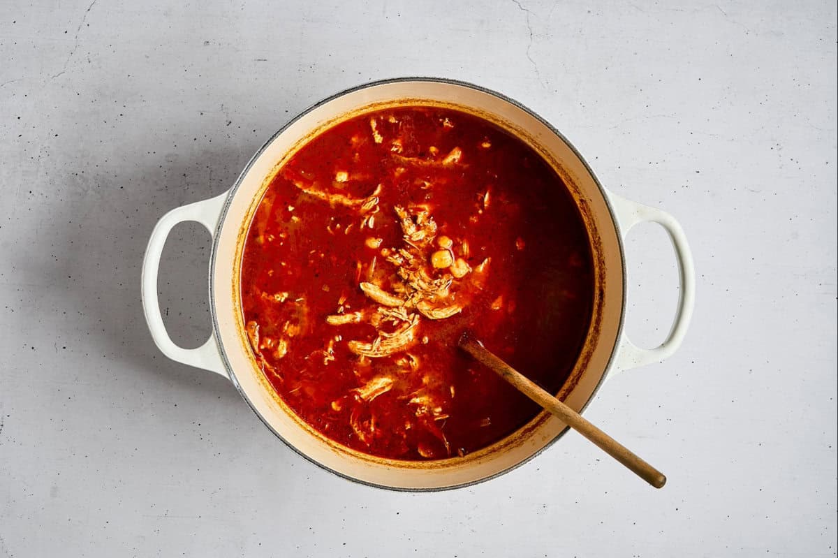 pozole rojo with chicken in a dutch oven.