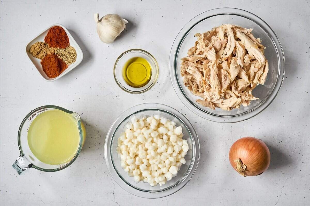 portioned ingredients for chicken pozole rojo in individual containers.