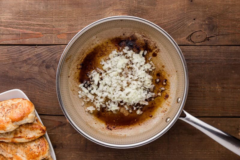 sauteeing onions in a skillet.
