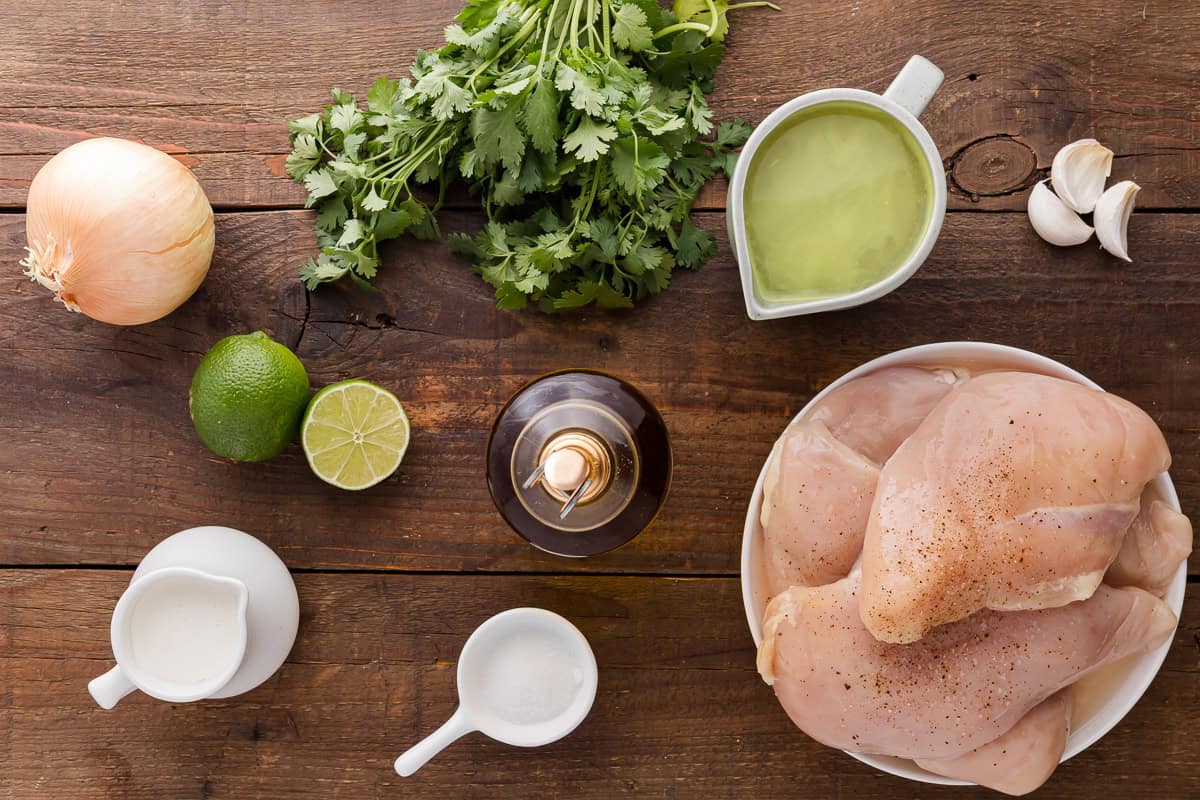 overhead view of measured ingredients for creamy cilantro lime chicken in individual bowls.