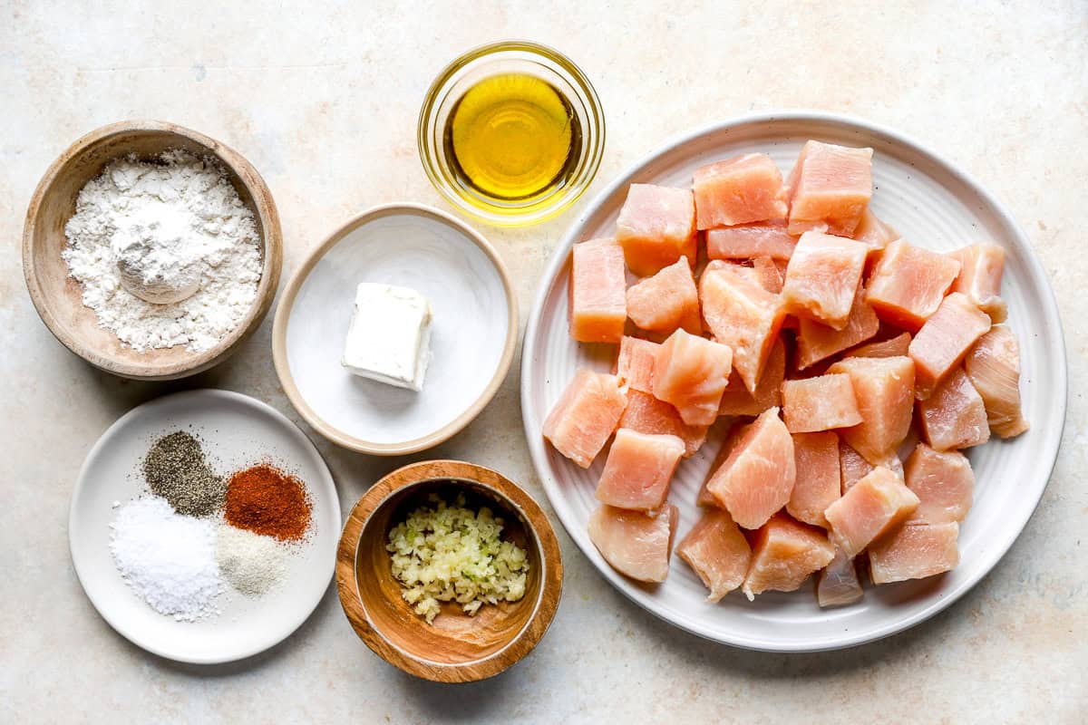 overhead view of portioned ingredients for chicken bites on individual plates.