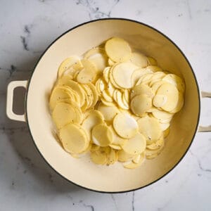 creamy potato slices in a braiser.