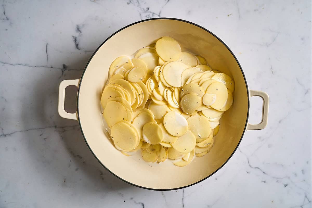 creamy potato slices in a braiser.