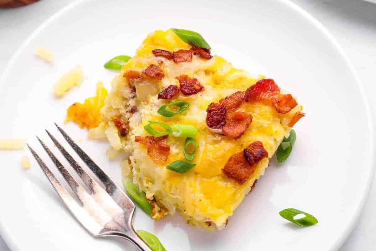 piece of amish casserole on a plate with a fork