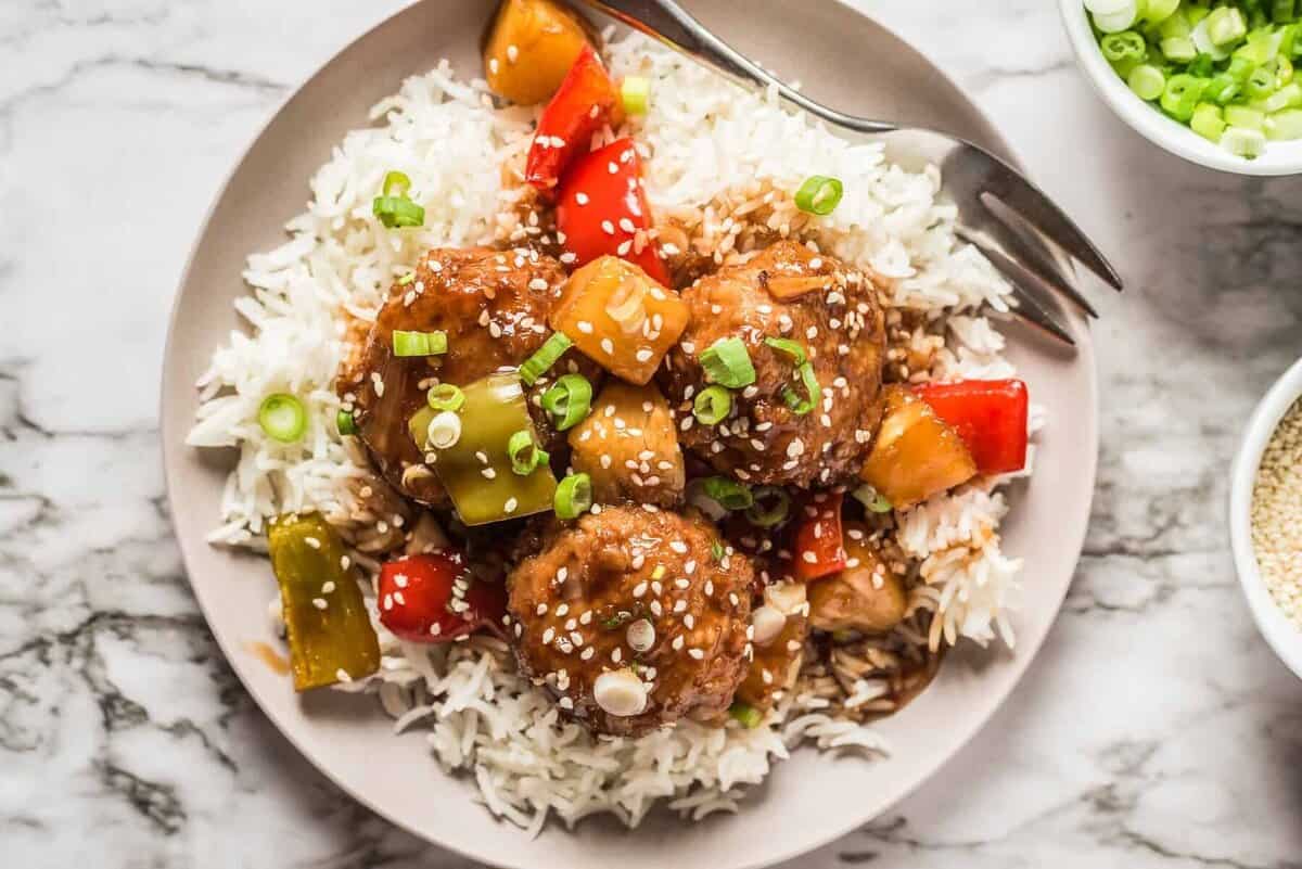 up close picture of plated Hawaiian chicken meatballs over rice