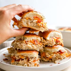 grabbing a chicken bacon ranch slider from a pyramid of five sliders.