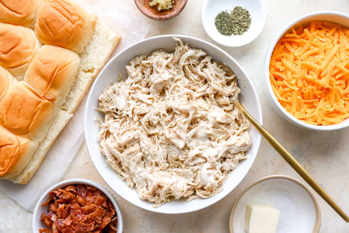shredded chicken mixed with ranch dressing in a white bowl.