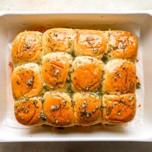 chicken bacon ranch sliders topped with seasoned melted butter before baking.