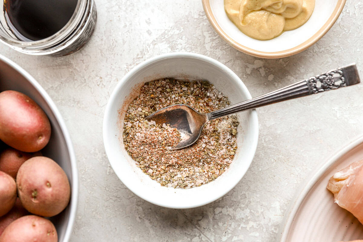 seasoning blend in a white bowl with a spoon.