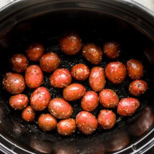 seasoned red baby potatoes in a crockpot.