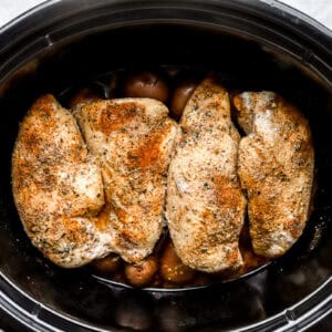 crockpot chicken and potatoes in a slow cooker after cooking.