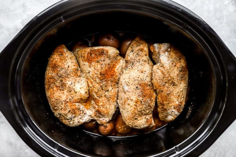 crockpot chicken and potatoes in a slow cooker after cooking.